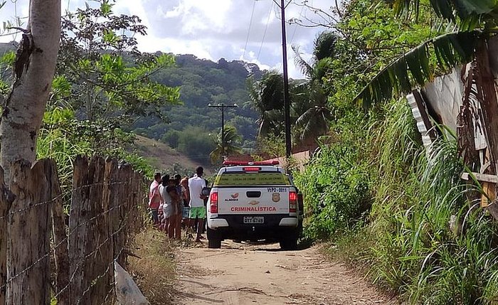 Populares observam corpo de vítima, também localizado nesta quinta-feira, no bairro de Rio Novo