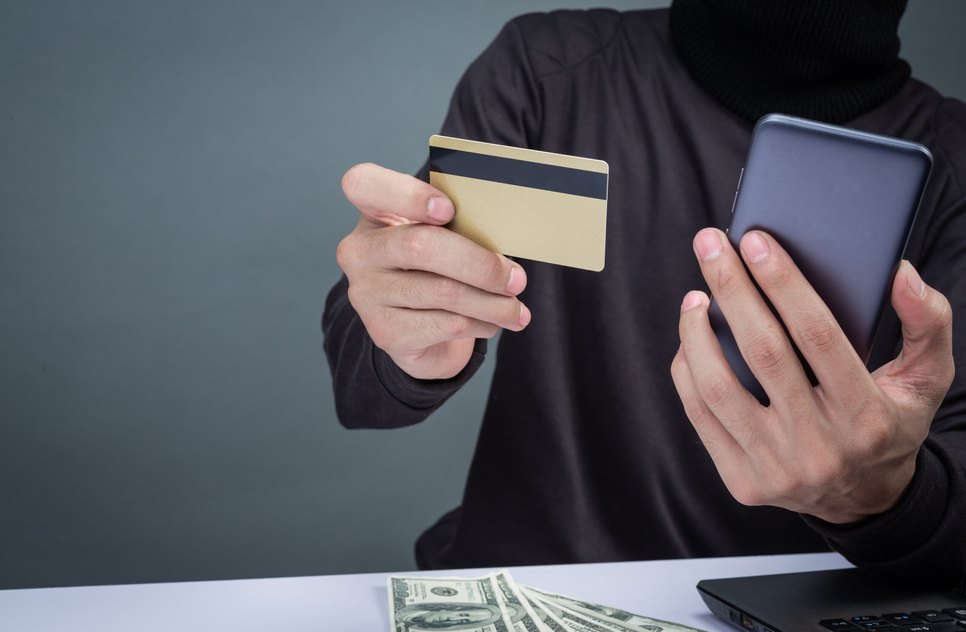 thieves-wear-black-hat-hold-phone-smart-card-gray-scaled
